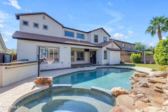 view of pool with an in ground hot tub and a patio area