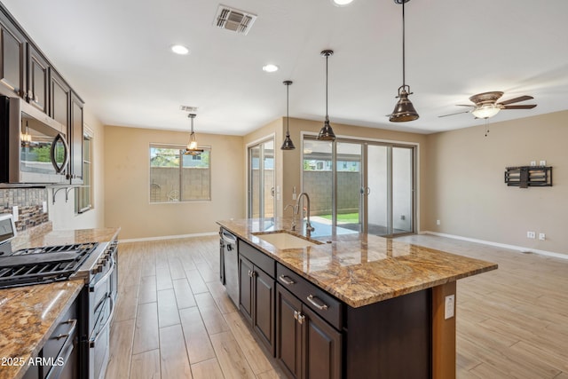 9921 E Acceleration Dr, Mesa, AZ 85212 - kitchen featuring stainless steel appliances, a sink, baseboards, recessed lighting, and light wood-type flooring