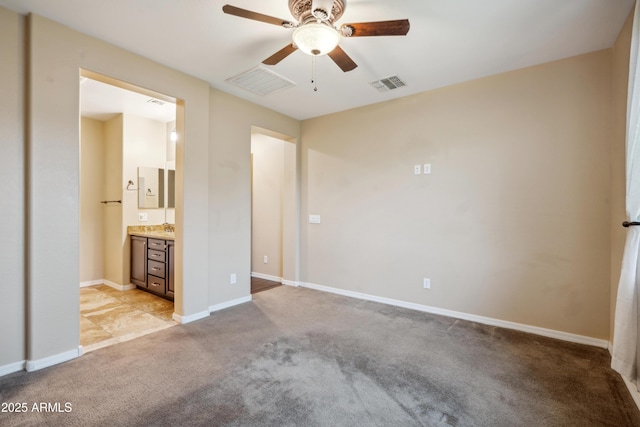 9921 E Acceleration Dr, Mesa, AZ 85212 - unfurnished bedroom with light carpet, baseboards, connected bathroom, and ceiling fan