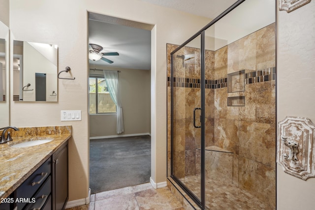 9921 E Acceleration Dr, Mesa, AZ 85212 - full bathroom with a ceiling fan, vanity, a stall shower, and baseboards