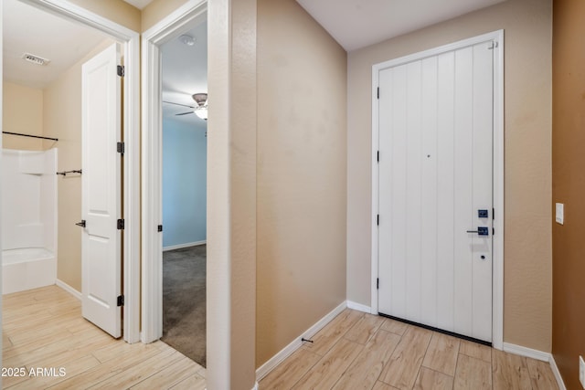 9921 E Acceleration Dr, Mesa, AZ 85212 - foyer with light wood-style flooring, ceiling fan, and baseboards