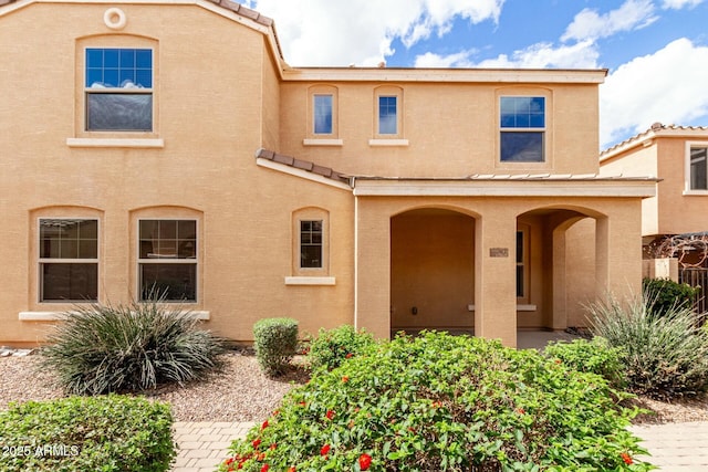 view of front of home with stucco siding and a tiled roof