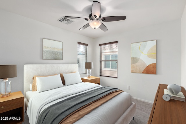 carpeted bedroom featuring visible vents, baseboards, and ceiling fan