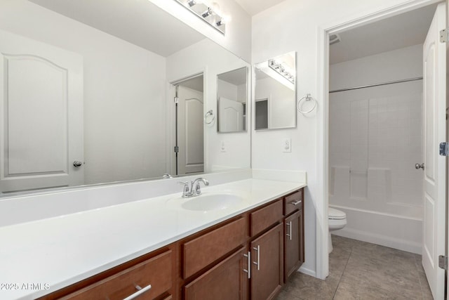 full bath featuring tile patterned flooring, toilet, vanity, and  shower combination