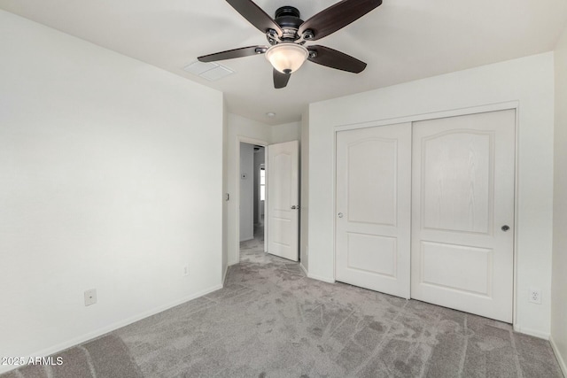 unfurnished bedroom featuring visible vents, baseboards, ceiling fan, carpet flooring, and a closet