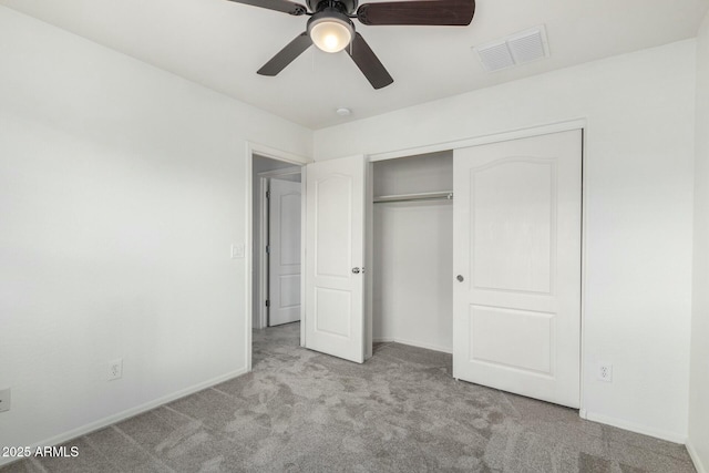 unfurnished bedroom with visible vents, a closet, carpet, baseboards, and ceiling fan