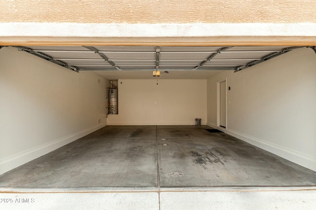 garage with a garage door opener, water heater, and baseboards