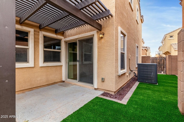 doorway to property with fence, stucco siding, a lawn, a patio area, and a pergola