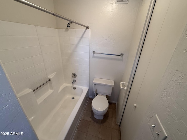 16602 N 25th St Unit 217, Phoenix, AZ 85032 - bathroom featuring tile patterned flooring, toilet,  shower combination, and a textured wall