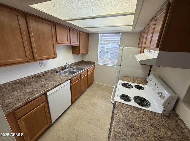16602 N 25th St Unit 217, Phoenix, AZ 85032 - kitchen with white appliances, a sink, brown cabinetry, and dark countertops