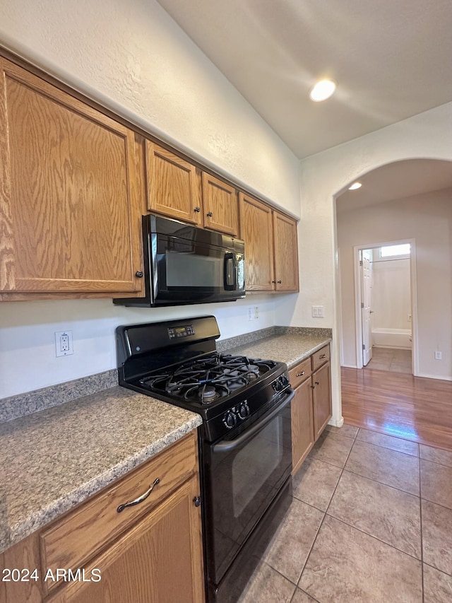 kitchen featuring light tile patterned floors and black appliances