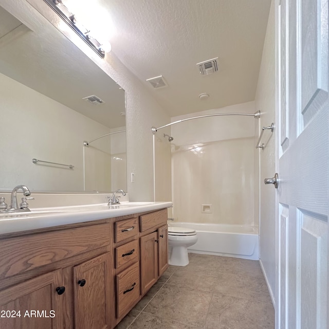 full bathroom featuring toilet, bathing tub / shower combination, a textured ceiling, vanity, and tile patterned flooring