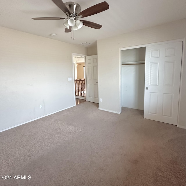 unfurnished bedroom with carpet floors, ceiling fan, and a closet