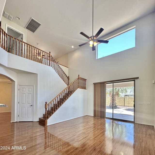 unfurnished living room with wood-type flooring and ceiling fan