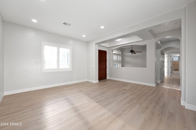 unfurnished living room featuring ceiling fan and light hardwood / wood-style flooring