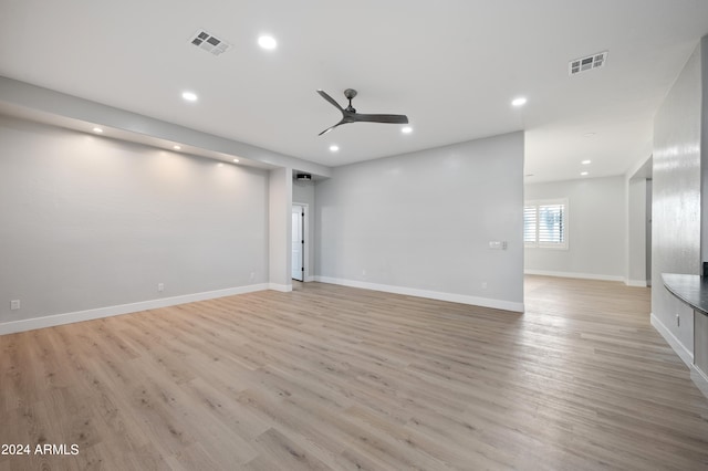 unfurnished living room featuring light wood-type flooring and ceiling fan