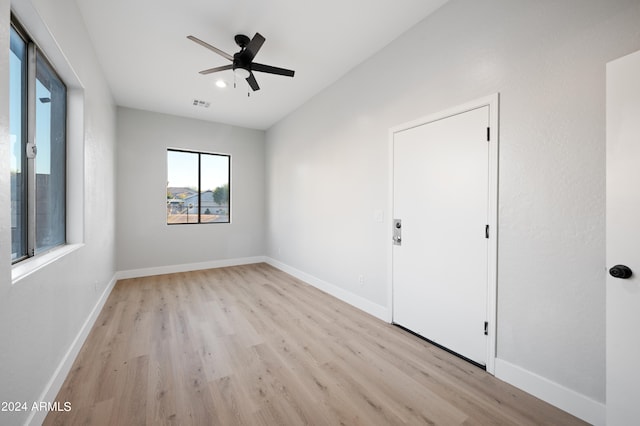 empty room with light wood-type flooring and ceiling fan