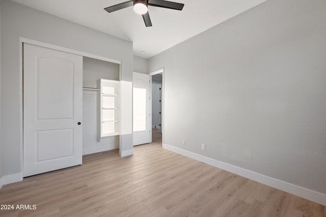 unfurnished bedroom with a closet, light hardwood / wood-style floors, and ceiling fan