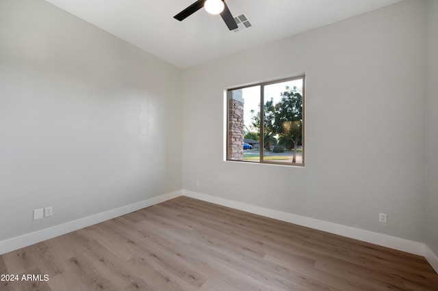 empty room with light hardwood / wood-style flooring and ceiling fan