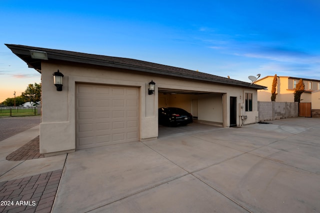 view of garage at dusk