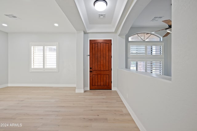 foyer entrance with ceiling fan and light hardwood / wood-style flooring