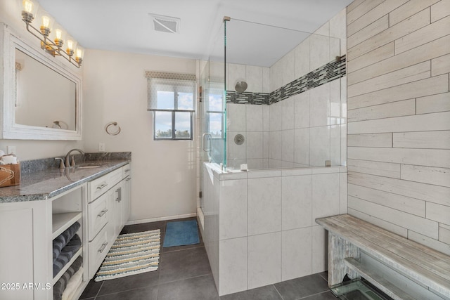 bathroom with tile patterned floors, visible vents, vanity, and a walk in shower