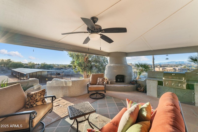 view of patio with an outdoor living space with a fireplace, area for grilling, a grill, and ceiling fan