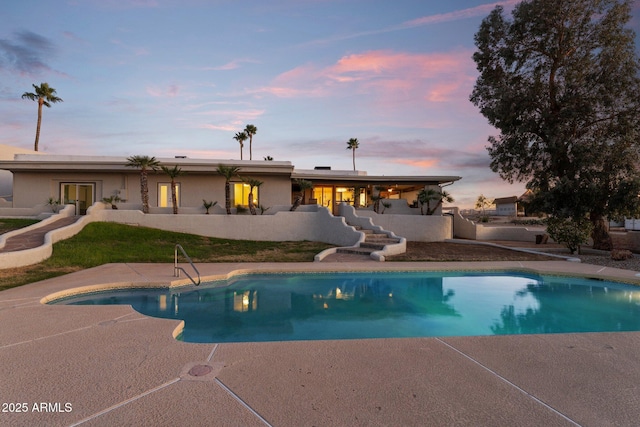 outdoor pool with a patio area