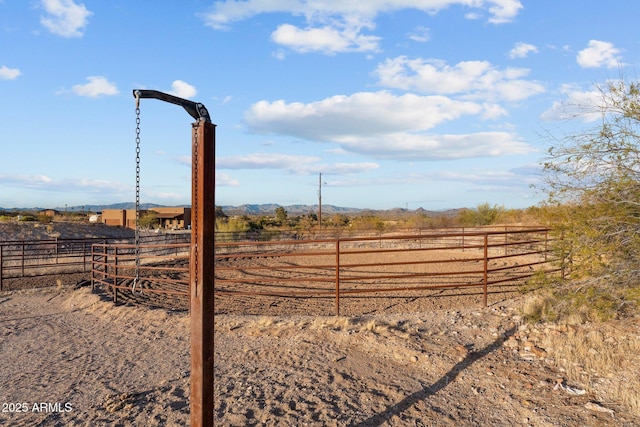 view of yard with a rural view and fence