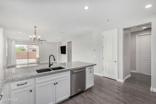kitchen with dishwasher, a sink, a chandelier, white cabinets, and light stone counters