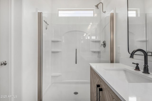 full bathroom with walk in shower, vanity, and plenty of natural light