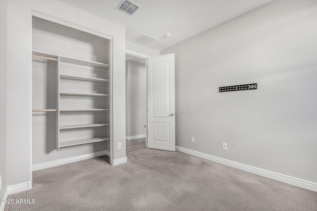unfurnished bedroom with carpet flooring, baseboards, and a closet