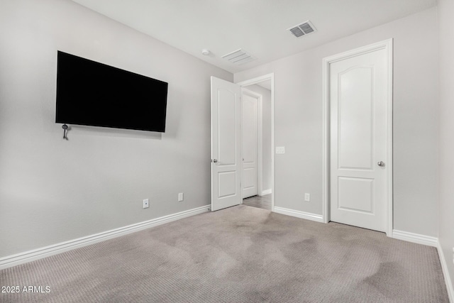 unfurnished bedroom featuring baseboards and carpet floors
