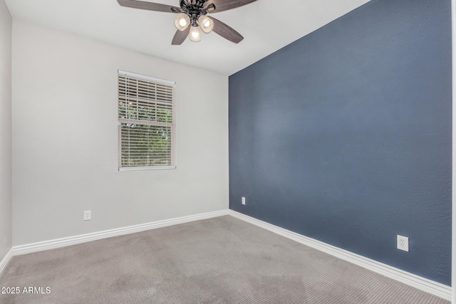 empty room featuring ceiling fan, carpet floors, and baseboards