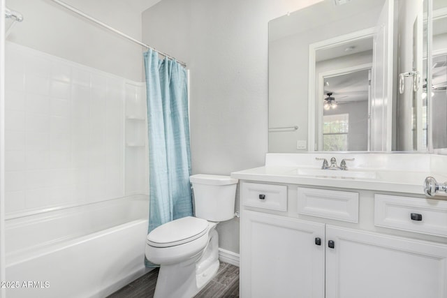full bathroom featuring toilet, ceiling fan, shower / tub combo with curtain, vanity, and wood finished floors