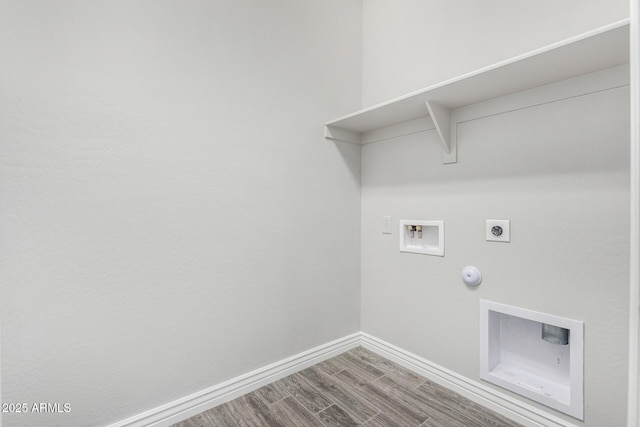 laundry area with gas dryer hookup, hookup for an electric dryer, washer hookup, baseboards, and wood finished floors
