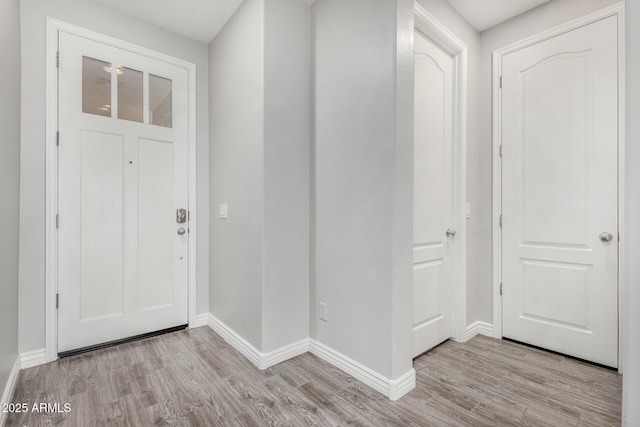 entrance foyer featuring light wood finished floors and baseboards