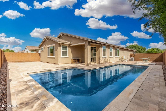 back of property featuring stucco siding, a patio area, and a fenced backyard