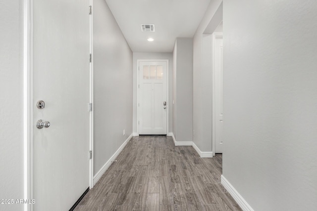 hall with wood finished floors and baseboards