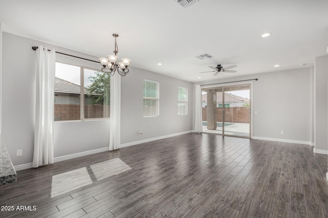 unfurnished room featuring dark wood-style flooring, a chandelier, ceiling fan, baseboards, and recessed lighting