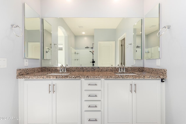 bathroom featuring an enclosed shower and vanity