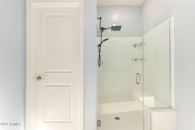 bathroom with a shower with shower door