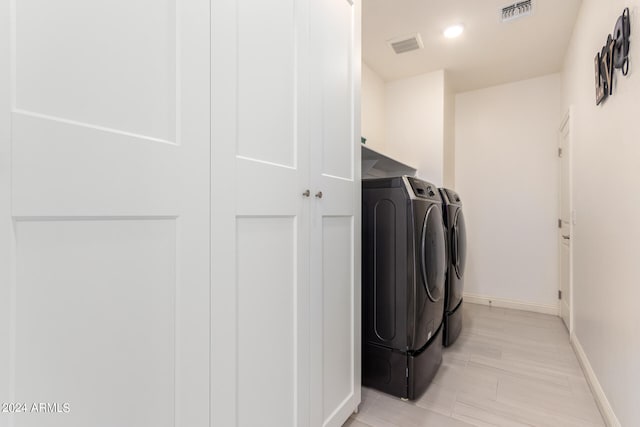 laundry area with separate washer and dryer