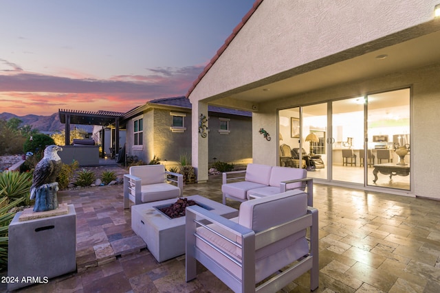 patio terrace at dusk featuring an outdoor living space with a fire pit