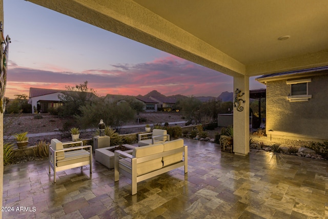 patio terrace at dusk featuring an outdoor hangout area