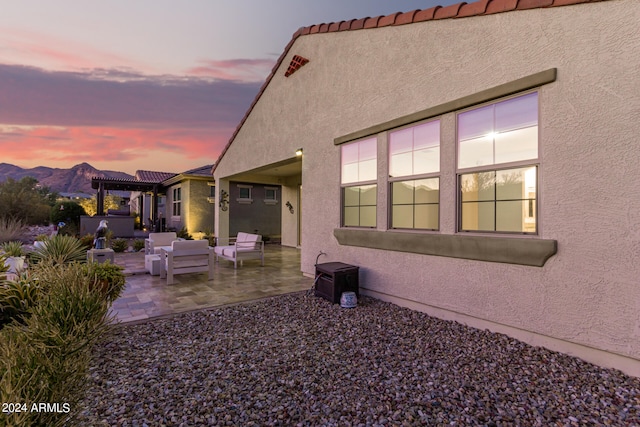 exterior space featuring a mountain view, an outdoor living space, and a patio