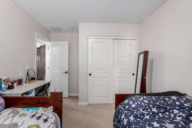 bedroom with baseboards, a closet, light carpet, and visible vents