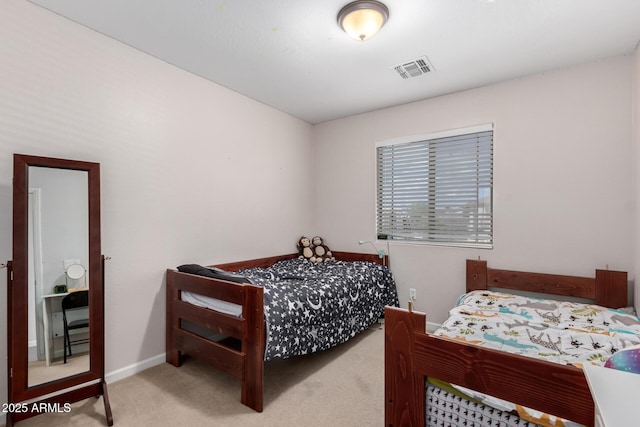 bedroom featuring visible vents, baseboards, and carpet