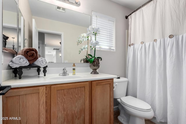 bathroom featuring visible vents, curtained shower, toilet, and vanity