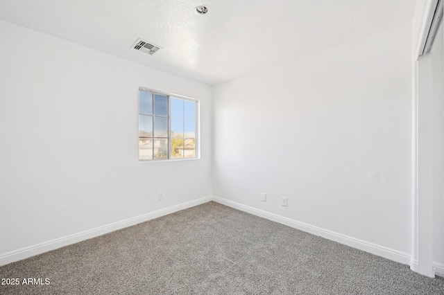 carpeted empty room featuring visible vents and baseboards